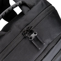 Close-up of a black backpack zipper with brand logo on a white background