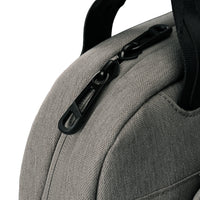 Close-up of a gray textured fabric bag with a black zipper pull and black strap on a white background.